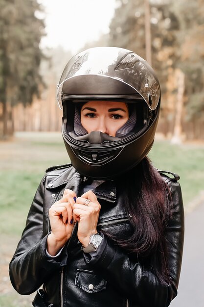 Premium Photo The Beautiful Brunette Riding A Motorcycle In The Park