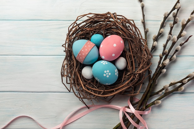 Premium Photo Blue And Pink Colored Eggs In Nest And Pussy Willow