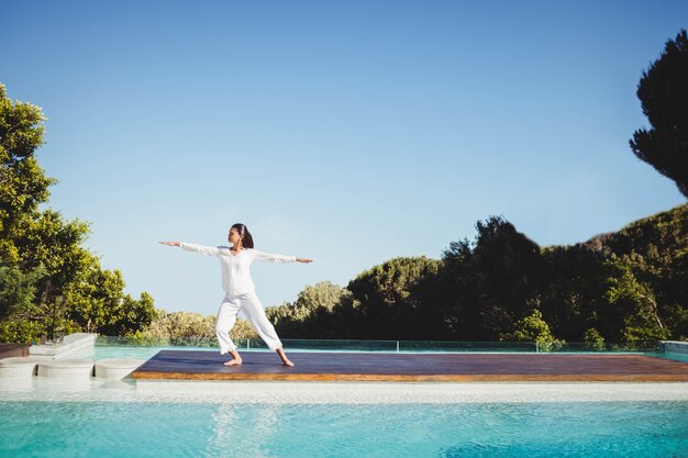 Premium Photo Calm Brunette Doing Yoga By The Pool