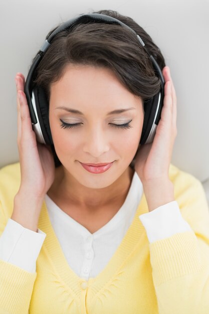 Premium Photo Calm Casual Brunette In Yellow Cardigan Enjoying Music