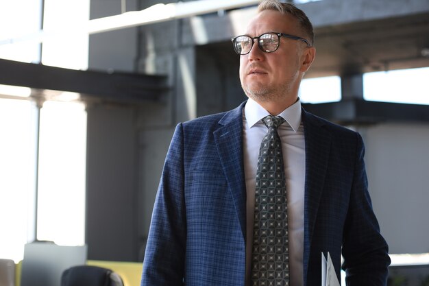 Premium Photo Confident Pensive Mature Business Man In Modern Office