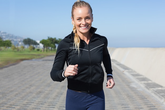 Premium Photo Fit Blonde Jogging On The Pier