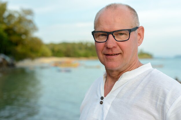 Premium Photo Happy Mature Handsome Tourist Man Smiling Against View