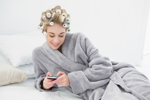 Premium Photo Happy Relaxed Blonde Woman In Hair Curlers Using Her