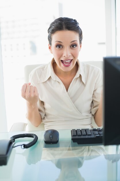 Premium Photo Joyful Stylish Brunette Businesswoman Raising Her Fists