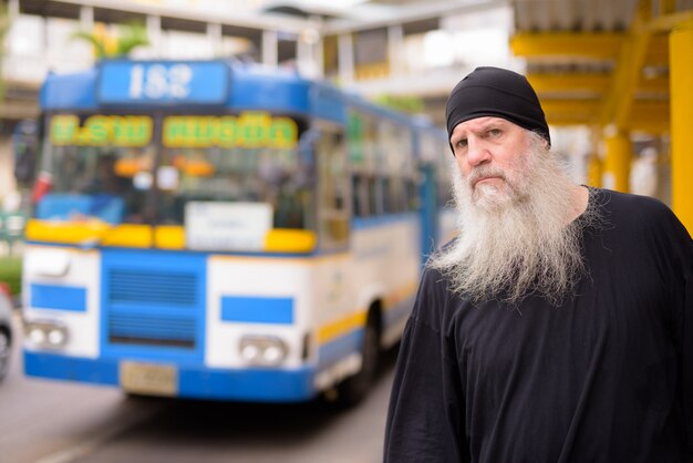 Premium Photo Mature Handsome Bearded Hipster Man Waiting At The Bus Stop