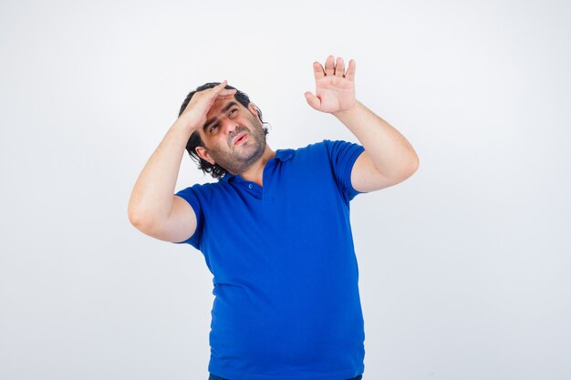 Free Photo Mature Man In Blue T Shirt Jeans Looking Far Away With