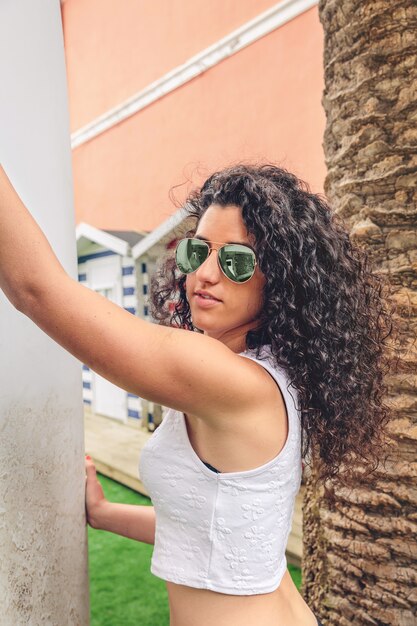 Premium Photo Portrait Of Curly Brunette Surfer Woman With White Top