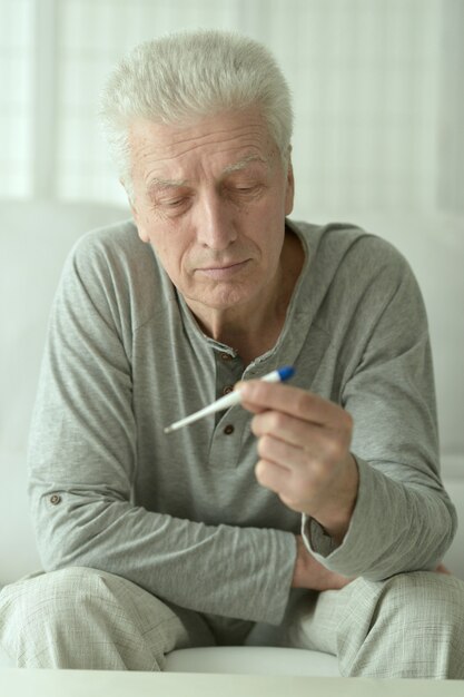 Premium Photo Portrait Of Sick Mature Man With Thermometer