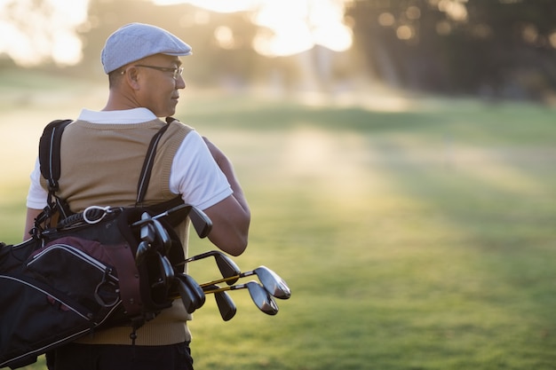 Premium Photo Rear View Of Mature Man Carrying Golf Bag