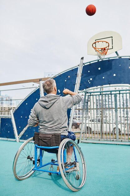 Premium Photo Rear View Of Mature Man With Disability Sitting In