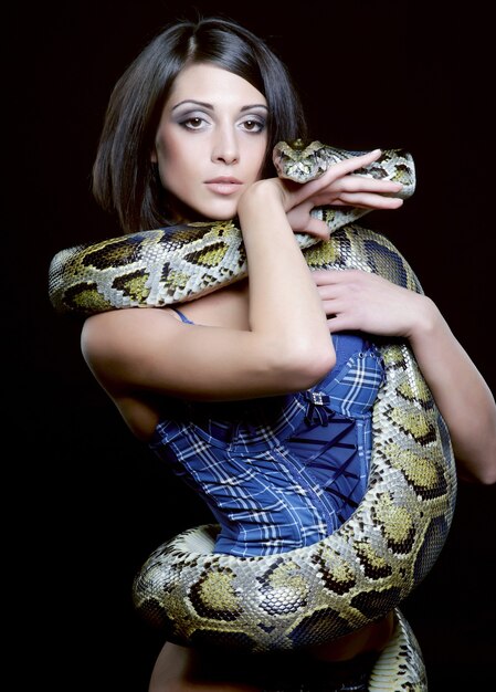 Premium Photo Sexy Brunette Holding Python Over Black