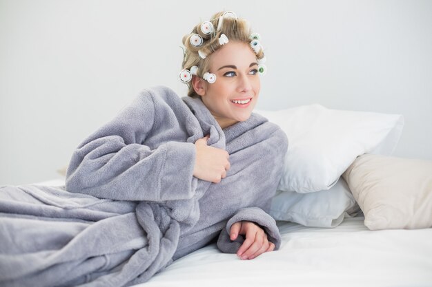 Premium Photo Smiling Relaxed Blonde Woman In Hair Curlers Posing