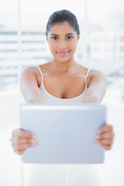 Premium Photo Smiling Toned Brunette Holding Tablet