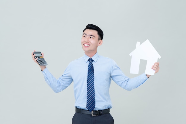 young-smiling-asian-male-real-estate-agent-holding-calculator-house-cutout_8087-3805.jpg
