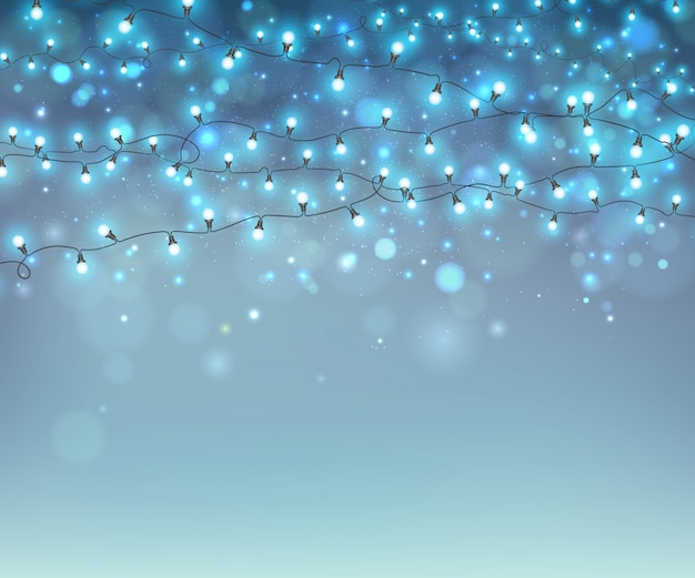 Rozjarzone bożenarodzeniowe girlandy na błękitnym tle z bokeh Premium Wektorów