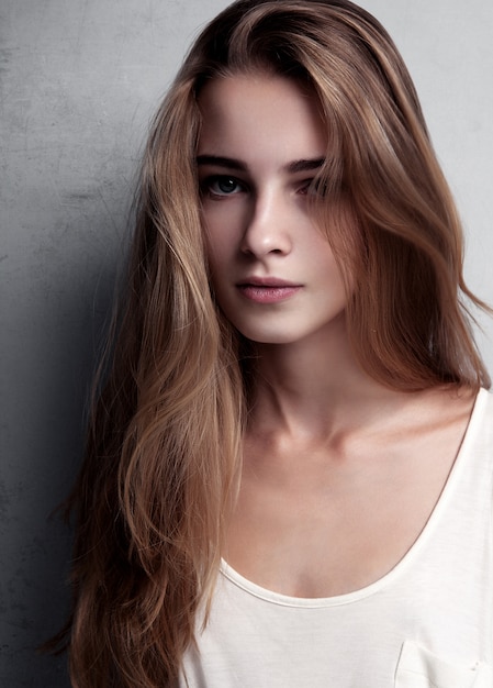 Test modelu z młodą piękną modelką noszącą białą koszulkę w studio. kolor portret Premium Zdjęcia