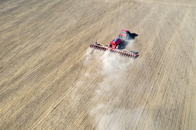 Un Agricultor En Un Tractor Prepara La Tierra Con Un Cultivador De Siembra Foto Premium