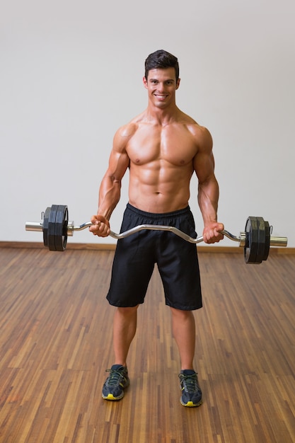 Barbudo De Elevaci N Del Hombre Muscular Descamisado En Gimnasio Foto