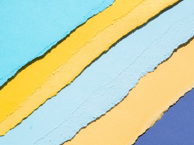Bordes de papel rasgado abstracto naranja y azul Foto gratis
