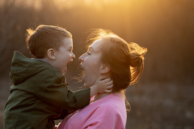 Cerca De Una Hermosa Madre Y Su Hijo Divirtiéndose Al Aire Libre Niño Lindo Sujeto Por Su Madre 