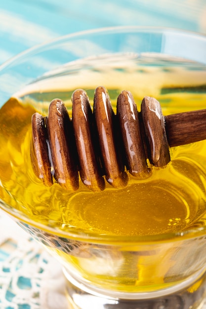 Cerrar cucharón y miel en un tazón | Foto Gratis
