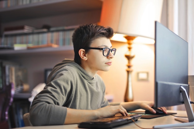 Chico Estudiante Usando Una Computadora Foto Premium