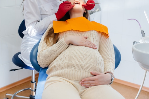 Un Dentista Profesional Trata Y Examina La Cavidad Bucal De Una Mujer Embarazada En Un 