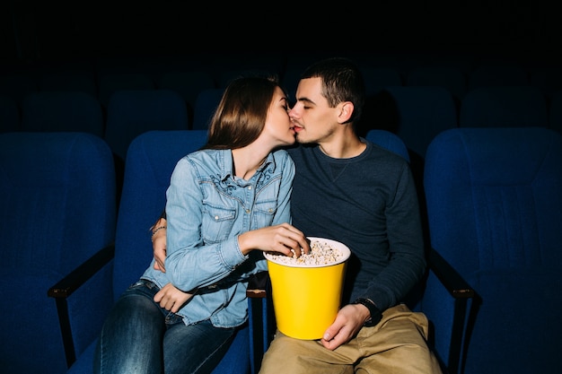 Dia Del Cine Joven Hermosa Pareja Besandose Mientras Ve La Pelicula Romantica En El Cine Foto Gratis