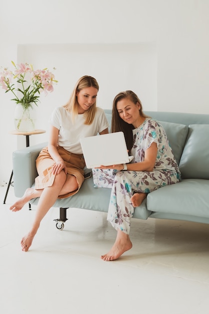 Dos Adorables Mujeres Jóvenes Charlando En Casa En El Sofá Tomando