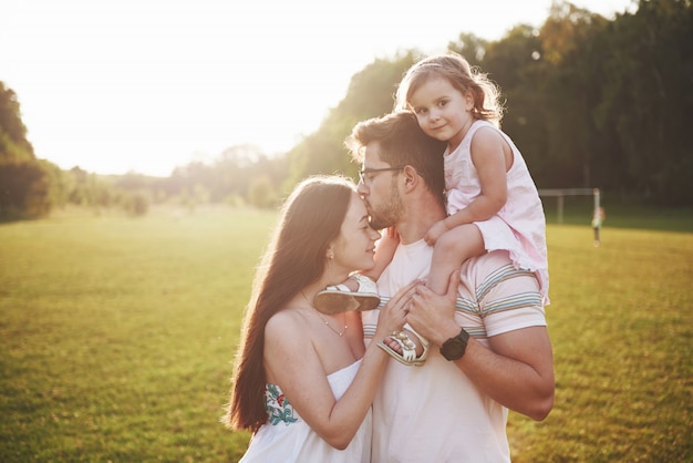 Familia Feliz Padre De Madre E Hija De Bebe En La Naturaleza Al Atardecer Foto Premium