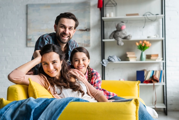 Familia feliz sentado en el sof???????â????â? ?¢â??¬â??¢??????¢â??¬? ???¢?¢â?š?¬?¢â?ž?¢???????â?????¢?¢â?š?¬???? ?????????¢???¢?¢â??¬?¡????¬???¢?¢â??¬?¾????¢???????â????â? ?¢â??¬â??¢?????????¢???¢?¢â??¬?¡????¬??â?¦????¡???????â?????¢?¢â?š?¬???¡??????¢â??¬?¡??â?š????¡ en la sala de estar Foto gratis