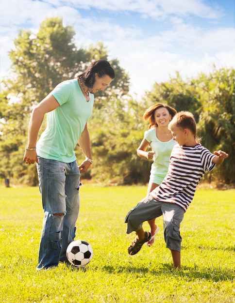 Feliz Padres Con Hijo Adolescente Jugando Con La Pelota Foto Gratis