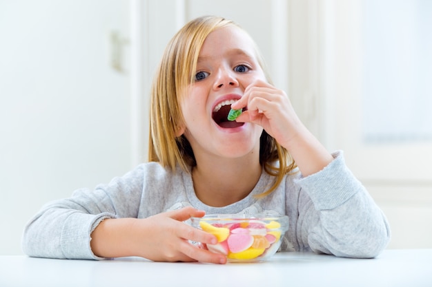 Hermoso niño comiendo dulces en casa Descargar Fotos gratis