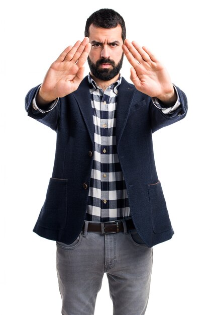 Hombre guapo haciendo señal de stop Foto Gratis Hombre guapo haciendo señal de stop Foto Gratis