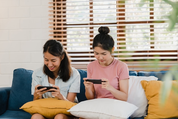 Jvenes Lesbianas Lgbtq Mujeres Pareja Usando El Telfono Mvil En Casa