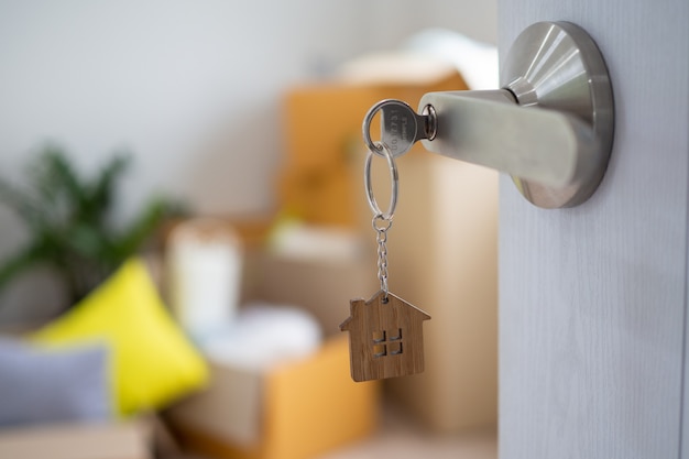 La llave de la casa para desbloquear una casa nueva está conectada a la puerta. Foto Premium 
