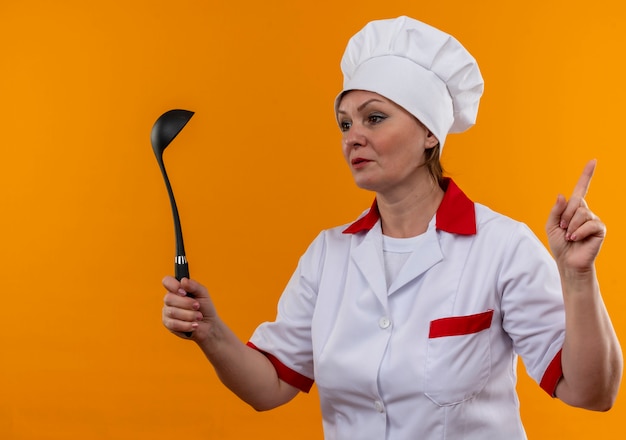 Mirando Al Lado De La Cocinera De Mediana Edad En Uniforme De Chef