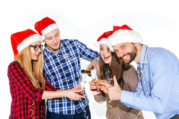 Muchas Mujeres Y Hombres Jovenes Bebiendo En La Fiesta De Navidad En Estudio Blanco Foto Gratis