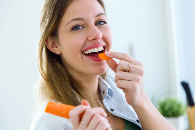 Mujer comiendo zanahoria Foto Premium 