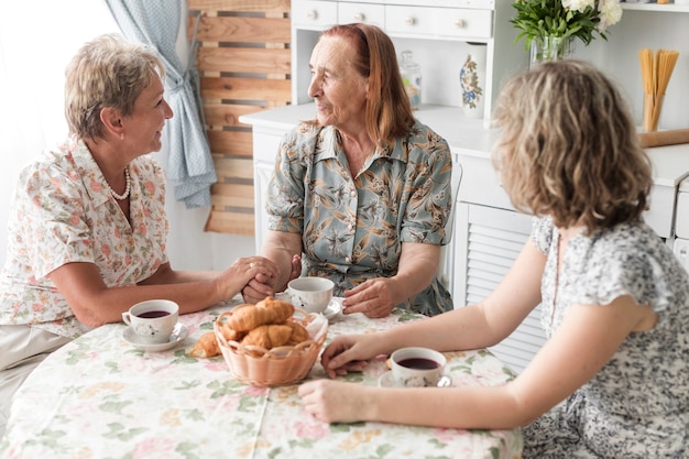 Mujer Desayunando Con Su Madre Y Su Abuela En Casa Foto Gratis