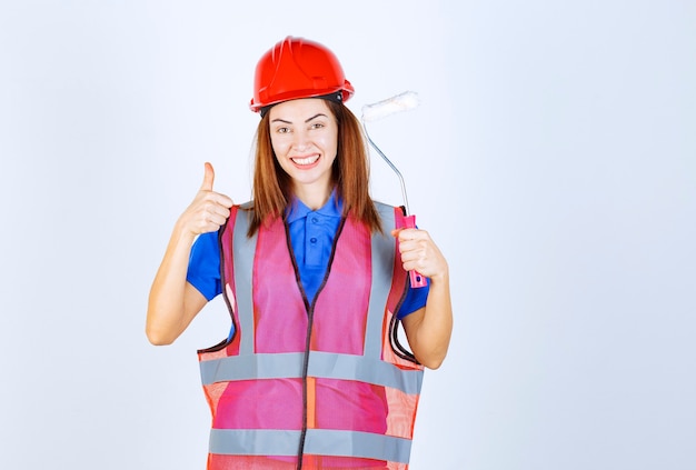 Mujer Ingeniera En Uniforme Sosteniendo Un Rodillo De Pintura De Color