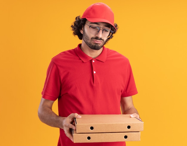 Repartidor Caucásico Joven Confuso En Uniforme Rojo Y Gorra Con Gafas Sosteniendo Y Mirando 7365