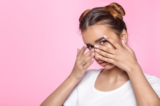 Retrato De Mujer Joven Hermosa Que Cubre Su Rostro Con Las Manos Sobre Fondo Rosa Foto Premium 9470