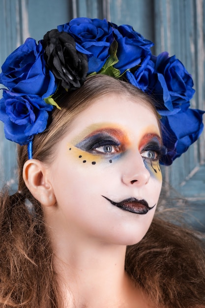 Retrato De Una Mujer Joven Con Maquillaje De Halloween Con Flores Azules Foto Premium