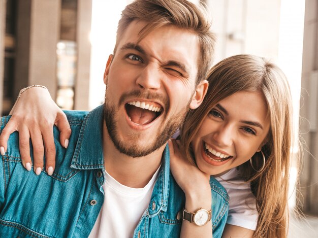 Portrait of smiling beautiful girl and her handsome boyfriend. woman in casual summer jeans clothes. . blink Free Photo