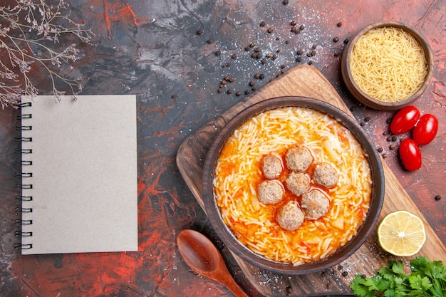 Sabrosa sopa de albóndigas con fideos a bordo de pasta de madera de