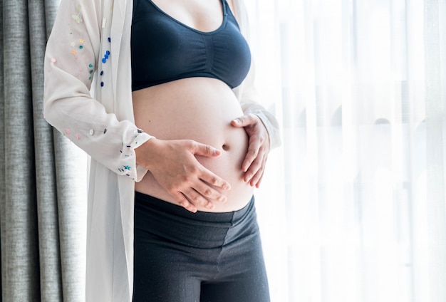 Vientre De Mujer Embarazada Con Manos Foto Premium 0053