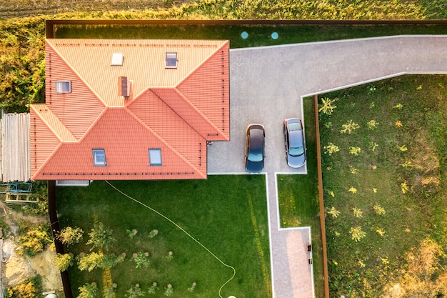 Vista aérea de una casa privada con techo de tejas rojas y patio con