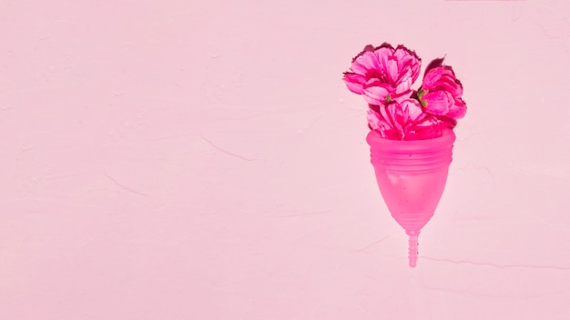 Vista superior copa menstrual con flores Foto gratis